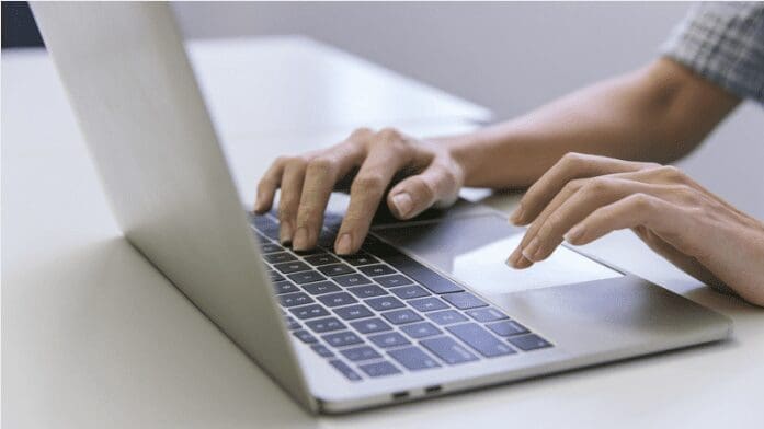 "Une personne tape sur le clavier d'un ordinateur portable